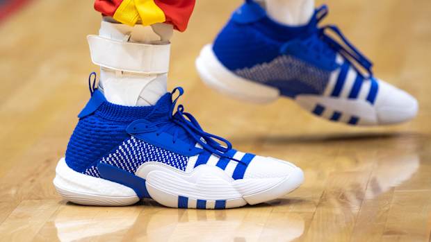 View of Trae Young's blue and white adidas shoes.